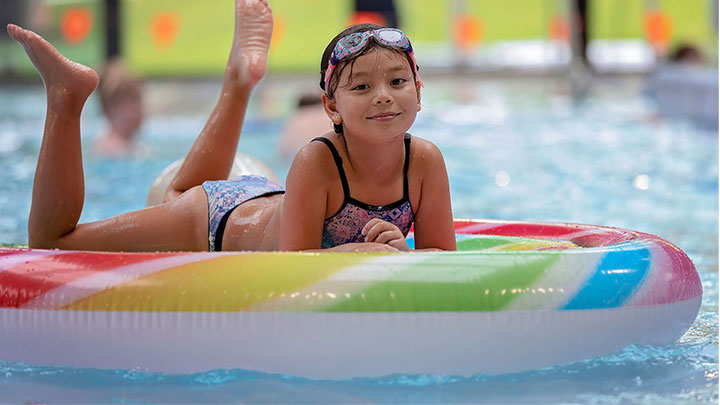 girl relaxing in pool on inflatable
